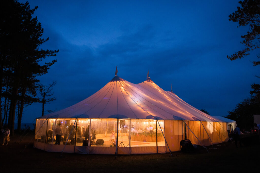 a wedding marquee glowing from inside at night for catering.